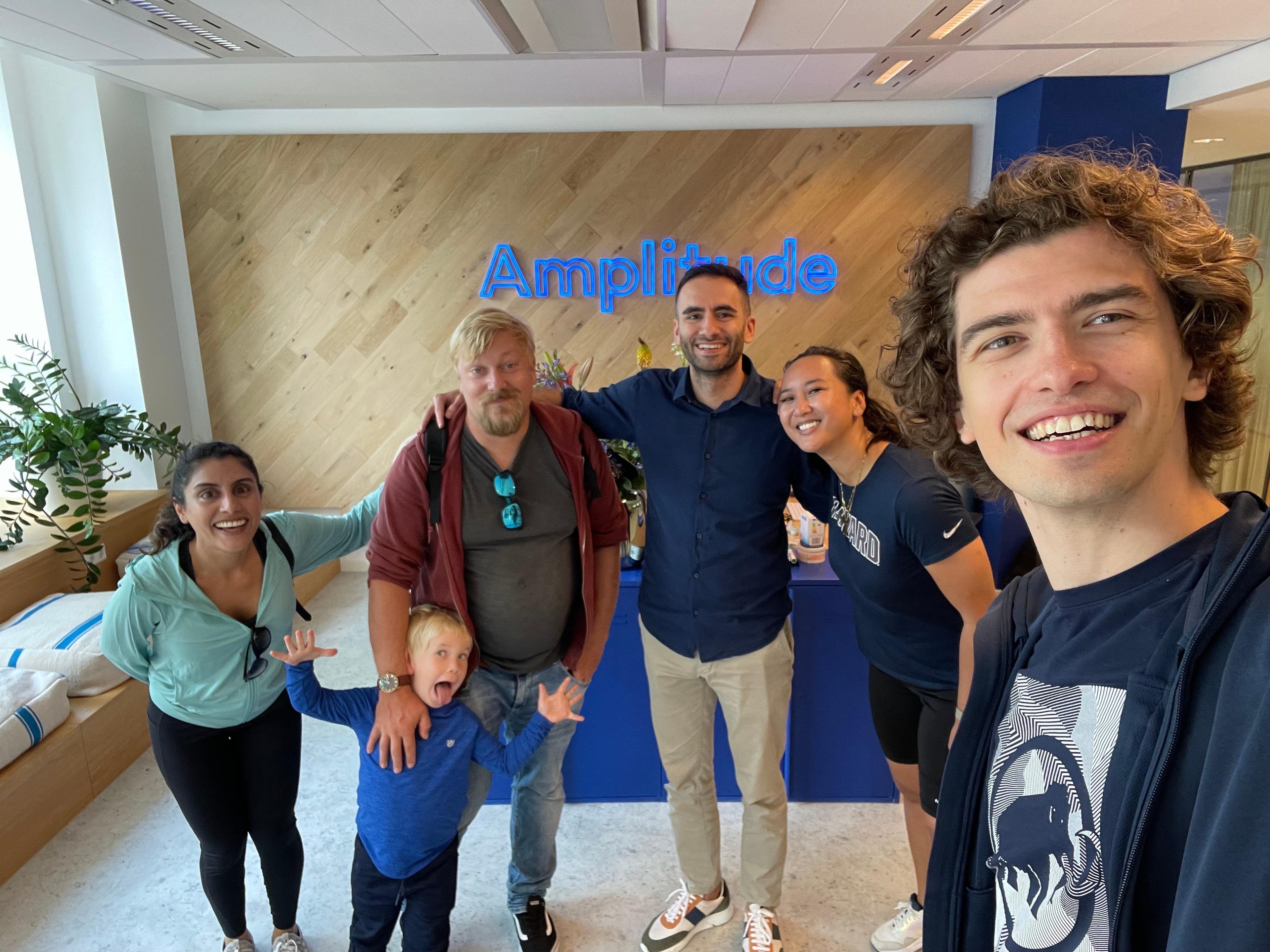 A team of coworkers gather in an office lobby